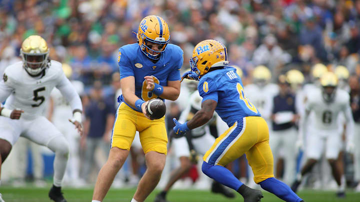 Pittsburgh Panthers quarterback Mason Heintschel (6) hands the ball off to running back Desmond Reid (0) during the first half against the Notre Dame Fighting Irish at Acrisure Stadium in Pittsburgh, PA on November 15, 2025. Pittsburgh Panthers quarterback Mason Heintschel (6) hands the ball off to running back Desmond Reid (0) during the first half against the Notre Dame Fighting Irish at Acrisure Stadium in Pittsburgh, PA on November 15, 2025.