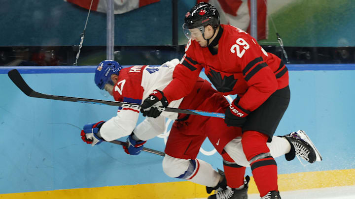 Feb 18, 2026; Milan, Italy; Nathan MacKinnon of Canada checks Filip Hronek of Czechia in a men's ice hockey quarterfinal during the Milano Cortina 2026 Olympic Winter Games at Milano Santagiulia Ice Hockey Arena. Mandatory Credit: Geoff Burke-Imagn Images