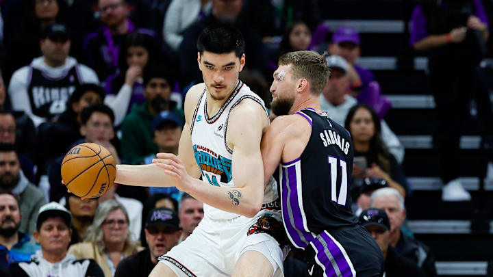 Mar 17, 2025; Sacramento, California, USA; Memphis Grizzlies center Zach Edey (14) controls the ball against Sacramento Kings forward Domantas Sabonis (11) during the second quarter at Golden 1 Center. Mandatory Credit: Sergio Estrada-Imagn Images