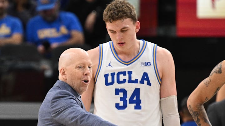 Dec 28, 2024; Inglewood, California, USA; UCLA Bruins head coach Mick Cronin talks to UCLA Bruins forward Tyler Bilodeau (34) and guard Kobe Johnson (0) during the second half against the Gonzaga Bulldogs at Intuit Dome. Mandatory Credit: Robert Hanashiro-Imagn Images