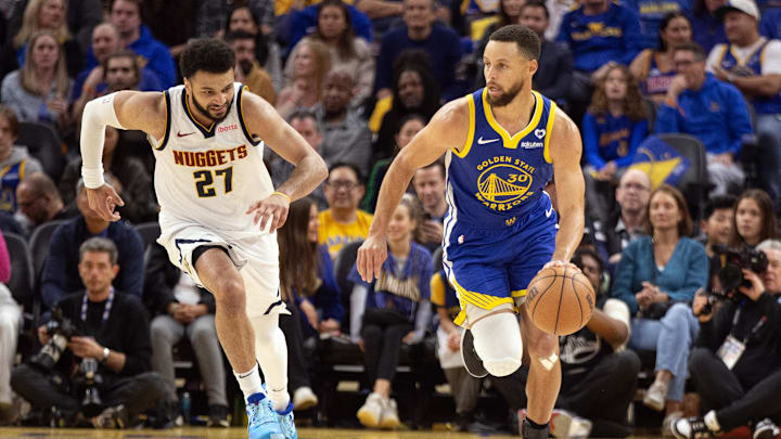Feb 25, 2024; San Francisco, California, USA; Denver Nuggets guard Jamal Murray (27) chases Golden State Warriors guard Stephen Curry (30) as he brings the ball up court during the second quarter at Chase Center. Mandatory Credit: D. Ross Cameron-Imagn Images