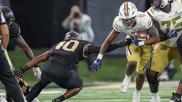 Trey Cooley (0), then of Georgia Tech, runs past Wake Forest defensive back DaShawn Jones (10) in 2023. 