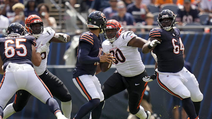 Aug 17, 2024; Chicago, Illinois, USA; Cincinnati Bengals defensive tackle Kris Jenkins Jr. (90) breaks through a block from Chicago Bears guard Nate Davis (64) to sack quarterback Caleb Williams (18) in the second quarter at Soldier Field. Mandatory Credit: Sam Greene-Imagn Images