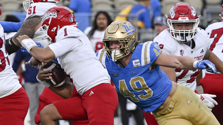 Nov 30, 2024; Pasadena, California, USA; UCLA Bruins linebacker Carson Schwesinger (49) sacks Fresno State Bulldogs quarterback Mikey Keene (1) during the second quarter at Rose Bowl. Mandatory Credit: Robert Hanashiro-Imagn Images
