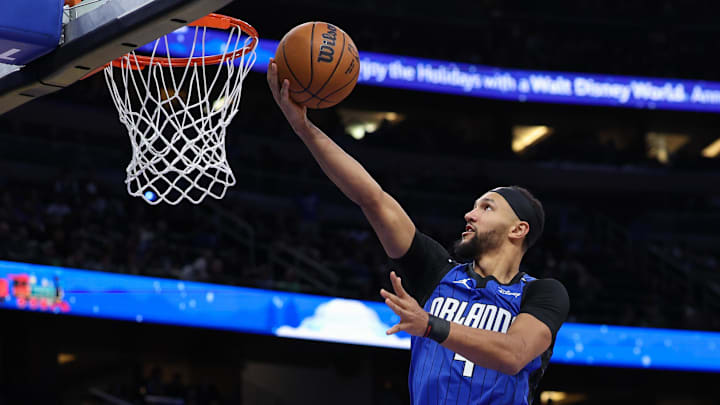 Dec 23, 2024; Orlando, Florida, USA; Orlando Magic guard Jalen Suggs (4) drives to the basket against the Boston Celtics in the third quarter at Kia Center. Mandatory Credit: Nathan Ray Seebeck-Imagn Images