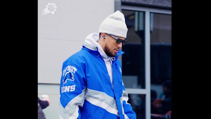 Devin Booker wears a Detroit Lions jacket on his way to play the Detroit Pistons at Little Caesars Arena. Devin Booker wears a Detroit Lions jacket on his way to play the Detroit Pistons at Little Caesars Arena.