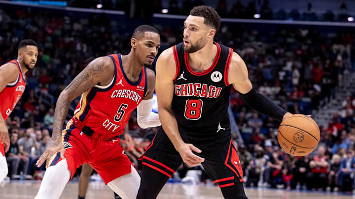 Oct 23, 2024; New Orleans, Louisiana, USA;  Chicago Bulls guard Zach LaVine (8) looks to pass the ball against New Orleans Pelicans guard Dejounte Murray (5) during the first half at Smoothie King Center. Mandatory Credit: Stephen Lew-Imagn Images