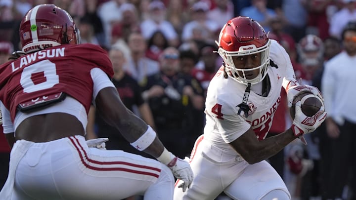 Oklahoma receiver Deion Burks runs after a catch against Alabama.