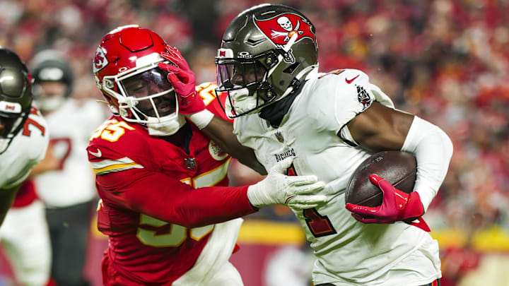 Nov 4, 2024; Kansas City, Missouri, USA; Tampa Bay Buccaneers running back Rachaad White (1) runs the ball against Kansas City Chiefs linebacker Joshua Uche (55) during the first half at GEHA Field at Arrowhead Stadium. Mandatory Credit: Jay Biggerstaff-Imagn Images