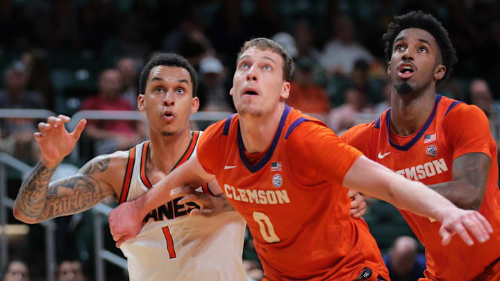 Dec 7, 2024; Coral Gables, Florida, USA; Miami Hurricanes center Lynn Kidd (1) battles for a rebound against Clemson Tigers center Viktor Lakhin (0) during the second half at Watsco Center. Dec 7, 2024; Coral Gables, Florida, USA; Miami Hurricanes center Lynn Kidd (1) battles for a rebound against Clemson Tigers center Viktor Lakhin (0) during the second half at Watsco Center.