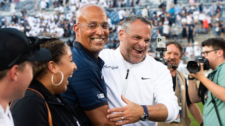 Penn State Athletic Director Pat Kraft, right, laughs with head coach James Franklin