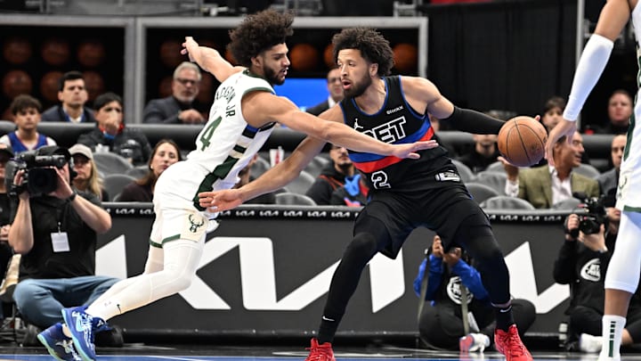 Dec 3, 2024; Detroit, Michigan, USA;  Detroit Pistons guard Cade Cunningham (2) tries to keep the ball away from Milwaukee Bucks guard Andre Jackson Jr. (44) in the first quarter at Little Caesars Arena. Mandatory Credit: Lon Horwedel-Imagn Images