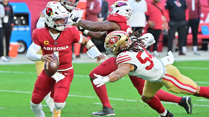 Jan 5, 2025; Glendale, Arizona, USA; Arizona Cardinals quarterback Kyler Murray (1) escapes a tackle by San Francisco 49ers linebacker Fred Warner (54) in the first half at State Farm Stadium. Mandatory Credit: Matt Kartozian-Imagn Images