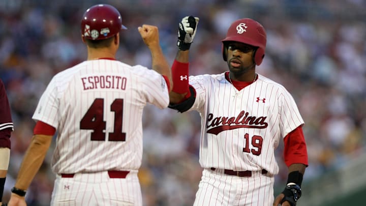June 19, 2011; Omaha, NE, USA; South Carolina Gamecocks center fielder Jackie Bradley Jr. (19) is congratulated by first base coach Sammy Esposito (41) after his single during the ninth inning against the Texas A&M Aggies during the 2011 College World Series at TD Ameritrade Park. South Carolina defeated Texas A&M 5-4. Mandatory Credit: Brace Hemmelgarn-Imagn Images