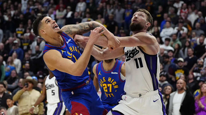 Jan 23, 2025; Denver, Colorado, USA; Denver Nuggets forward Michael Porter Jr. (1) and Sacramento Kings forward Domantas Sabonis (11) under the basket in the second half at Ball Arena. Mandatory Credit: Ron Chenoy-Imagn Images