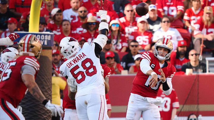 Oct 6, 2024; Santa Clara, California, USA; San Francisco 49ers quarterback Brock Purdy (13) throws the ball to tight end George Kittle (85) against the Arizona Cardinals during the fourth quarter at Levi's Stadium. Mandatory Credit: Kelley L Cox-Imagn Images