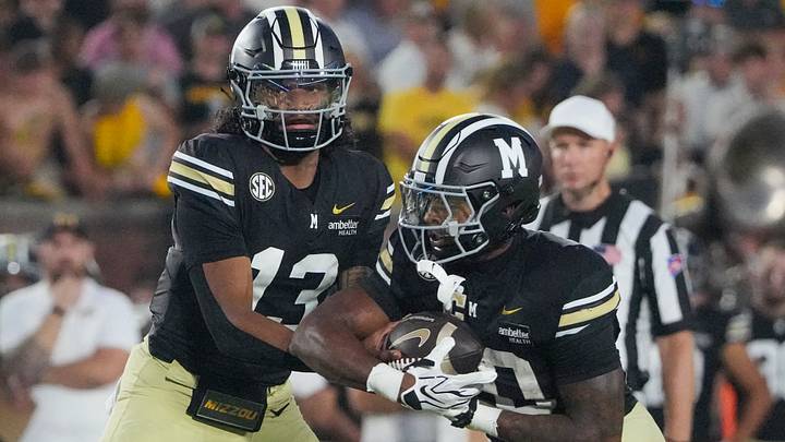 Sep 19, 2026; Columbia, Missouri, USA; Missouri Tigers quarterback Austin Simmons (13) hands off to running back Jamal Roberts (20) during the first half of the game at Faurot Field at Memorial Stadium. Mandatory Credit: Denny Medley-Imagn Images Sep 19, 2026; Columbia, Missouri, USA; Missouri Tigers quarterback Austin Simmons (13) hands off to running back Jamal Roberts (20) during the first half of the game at Faurot Field at Memorial Stadium. Mandatory Credit: Denny Medley-Imagn Images