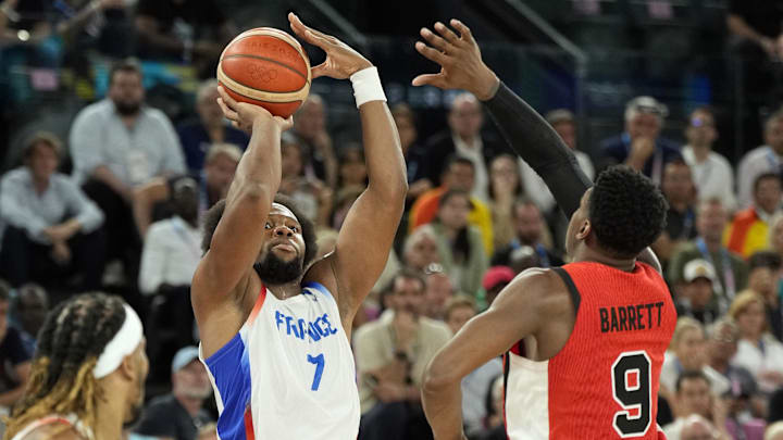 Aug 6, 2024; Paris, France; France power forward Guerschon Yabusele (7) shoots against Canada small forward RJ Barrett (9) in the fourth quarter in a men’s basketball quarterfinal game during the Paris 2024 Olympic Summer Games at Accor Arena. Mandatory Credit: Kyle Terada-Imagn Images