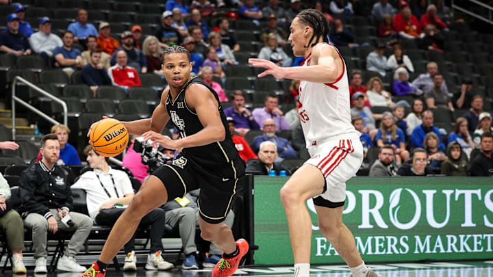 Mar 11, 2025; Kansas City, MO, USA; UCF Knights guard Keyshawn Hall (4) drives to the basket during the second half against the Utah Utes at T-Mobile Center. Mandatory Credit: William Purnell-Imagn Images