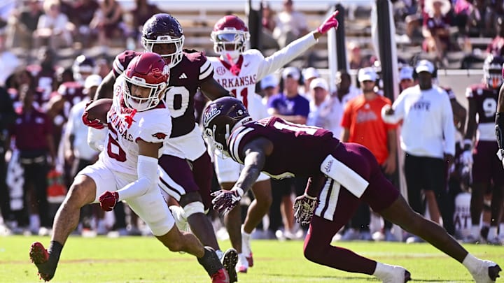 Oct 26, 2024; Starkville, Mississippi, USA; Arkansas Razorbacks wide receiver Isaiah Sategna (6) runs the ball while defended by Mississippi State Bulldogs safety Corey Ellington (10) during the fourth quarter at Davis Wade Stadium at Scott Field. Mandatory Credit: Matt Bush-Imagn Images