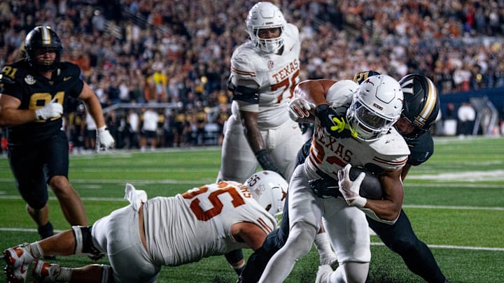 Texas Longhorns running back Jaydon Blue (23) is brought down short of the first down marker by Vanderbilt Commodores defensive lineman Yilanan Ouattara (5) during the second half of their game at FirstBank Stadium in Nashville, Tenn., Sunday, Oct. 27, 2024.