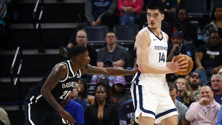 Oct 30, 2024; Memphis, Tennessee, USA; Memphis Grizzlies center Zach Edey (14) handles the ball as Brooklyn Nets forward Dorian Finney-Smith (28) defends during the first half at FedExForum. Mandatory Credit: Petre Thomas-Imagn Images