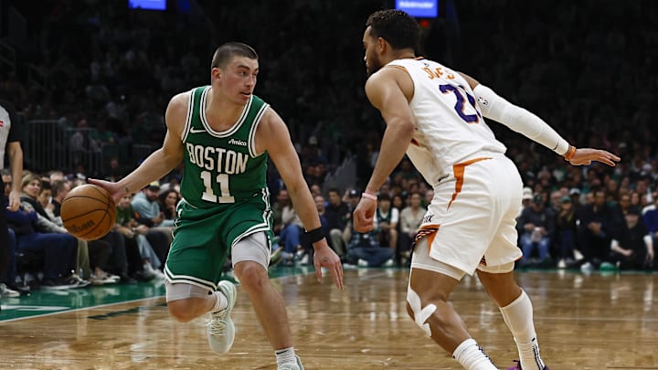 Apr 4, 2025; Boston, Massachusetts, USA; Boston Celtics guard Payton Pritchard (11) looks for an opening around Phoenix Suns guard Tyus Jones (21) during the second quarter at TD Garden. Mandatory Credit: Winslow Townson-Imagn Images