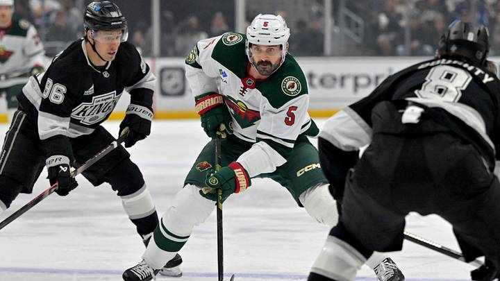 Jan 5, 2026; Los Angeles, California, USA; Minnesota Wild defenseman Jake Middleton (5) takes the puck between Los Angeles Kings left wing Andrei Kuzmenko (96) and defenseman Drew Doughty (8) in the first period at Crypto.com Arena. Mandatory Credit: Jayne Kamin-Oncea-Imagn Images Jan 5, 2026; Los Angeles, California, USA; Minnesota Wild defenseman Jake Middleton (5) takes the puck between Los Angeles Kings left wing Andrei Kuzmenko (96) and defenseman Drew Doughty (8) in the first period at Crypto.com Arena. Mandatory Credit: Jayne Kamin-Oncea-Imagn Images