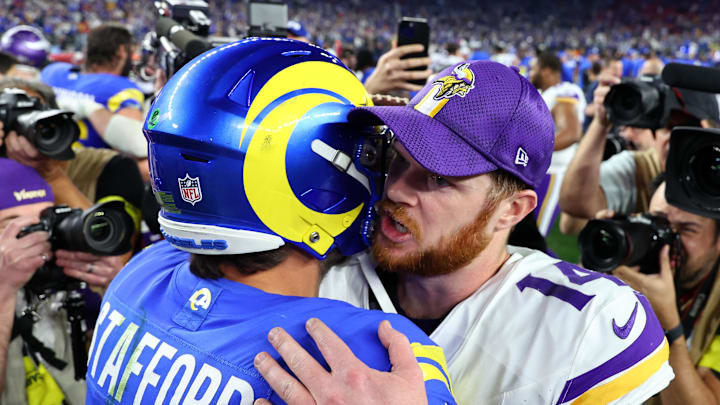 Jan 13, 2025; Glendale, AZ, USA; Minnesota Vikings quarterback Sam Darnold (14) and Los Angeles Rams quarterback Matthew Stafford (9) hug after the  NFC wild card game at State Farm Stadium. Mandatory Credit: Mark J. Rebilas-Imagn Images