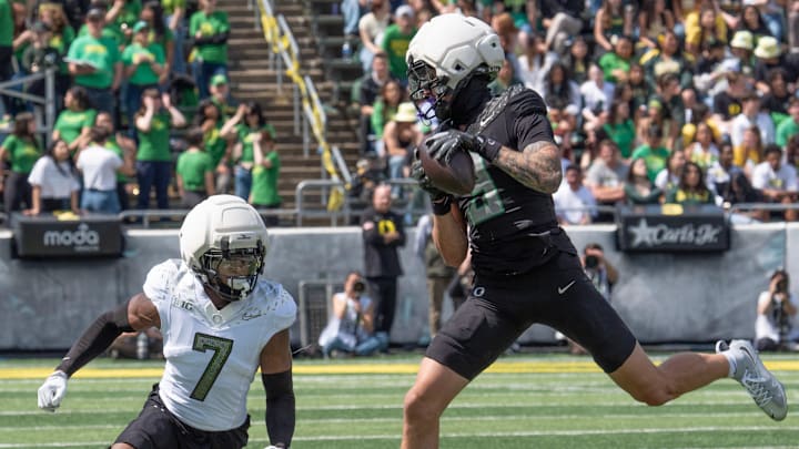 Combat Duck Kyler Kasper, right, pulls down a pass reception ahead of Fighting Duck Ify Obidegwu during the second half.