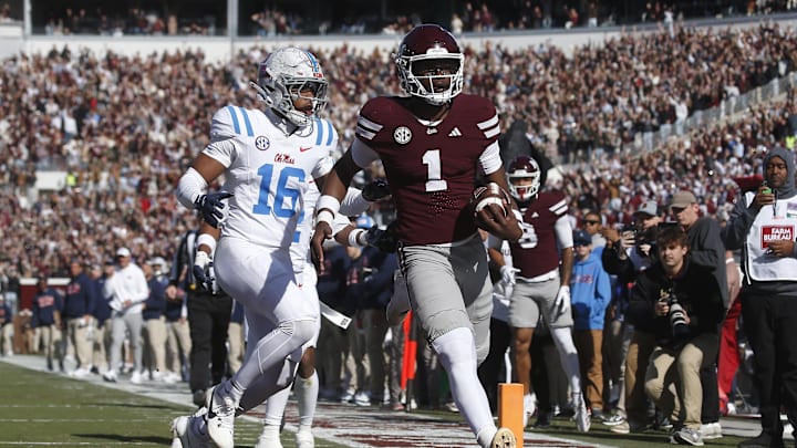 Nov 28, 2025; Starkville, Mississippi, USA; Mississippi State Bulldogs quarterback Kamario Taylor (1) runs to score a touchdown against the Mississippi Rebels in the first half at Davis Wade Stadium at Scott Field. Mandatory Credit: Petre Thomas-Imagn Images
