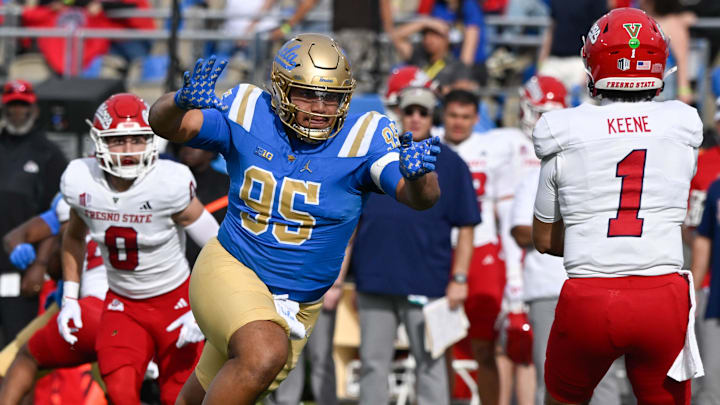 Nov 30, 2024; Pasadena, California, USA; UCLA Bruins defensive lineman Sitiveni Havili Kaufusi (95) pressures Fresno State Bulldogs quarterback Mikey Keene (1) during the second quarter at Rose Bowl. Mandatory Credit: Robert Hanashiro-Imagn Images