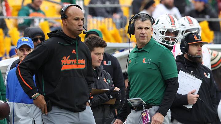 Nov 29, 2025; Pittsburgh, Pennsylvania, USA;  Miami Hurricanes defensive line coach Jason Taylor (left) and Hurricanes head coach Mario Cristobal (right) look on during the second quarter against the Pittsburgh Panthers at Acrisure Stadium. Mandatory Credit: Charles LeClaire-Imagn Images