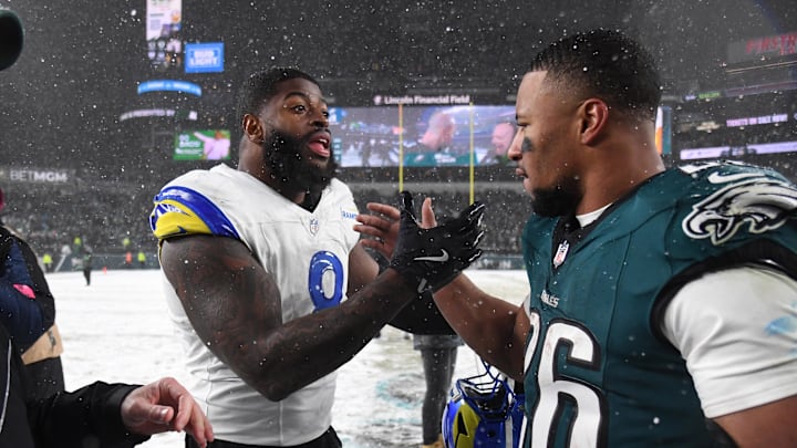 Jan 19, 2025; Philadelphia, Pennsylvania, USA; Los Angeles Rams linebacker Jared Verse (8) greets Philadelphia Eagles running back Saquon Barkley (26) after their 2025 NFC divisional round game at Lincoln Financial Field. Mandatory Credit: Eric Hartline-Imagn Images