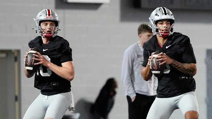 Ohio State Buckeyes quarterbacks Julian Sayin and Tavien St. Clair drop back to pass during spring football practice. Ohio State Buckeyes quarterbacks Julian Sayin and Tavien St. Clair drop back to pass during spring football practice.