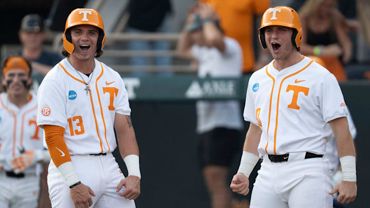 Tennessee's Reese Chapman (13) and Levi Clark (30) cheer for teammates Manny Marin (4) as he rounds the bases after hitting a home run at the NCAA college baseball Knoxville Regional final against Wake Forest on June 2, 2025, in Knoxville, Tenn.