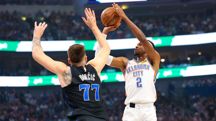 May 18, 2024; Dallas, Texas, USA; Oklahoma City Thunder guard Shai Gilgeous-Alexander (2) shoots over Dallas Mavericks guard Luka Doncic (77) during the first quarter in game six of the second round of the 2024 NBA playoffs at American Airlines Center. Mandatory Credit: Kevin Jairaj-Imagn Images