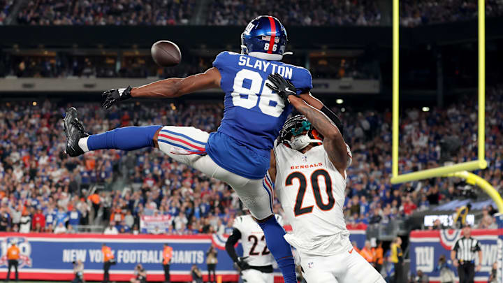 Oct 13, 2024; East Rutherford, New Jersey, USA; Cincinnati Bengals cornerback DJ Turner II (20) commits pass interference while defending a pass intended for New York Giants wide receiver Darius Slayton (86) during the third quarter at MetLife Stadium. 