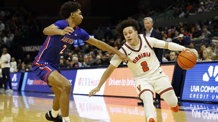 Dec 22, 2025; Charlottesville, Virginia, USA; Virginia Cavaliers guard Chance Mallory (2) drives to the basket as American University Eagles guard Madden Collins (2) defends in the second half at John Paul Jones Arena. Mandatory Credit: Geoff Burke-Imagn Images