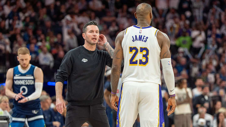Apr 27, 2025; Minneapolis, Minnesota, USA; Los Angeles Lakers head coach JJ Redick talks with forward LeBron James (23) in the fourth quarter against the Minnesota Timberwolves during game four of first round for the 2025 NBA Playoffs at Target Center. Mandatory Credit: Matt Blewett-Imagn Images Apr 27, 2025; Minneapolis, Minnesota, USA; Los Angeles Lakers head coach JJ Redick talks with forward LeBron James (23) in the fourth quarter against the Minnesota Timberwolves during game four of first round for the 2025 NBA Playoffs at Target Center. Mandatory Credit: Matt Blewett-Imagn Images