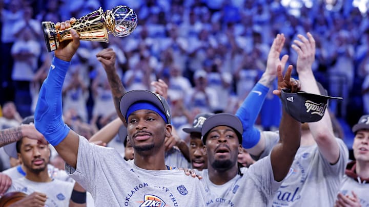 May 28, 2025; Oklahoma City, Oklahoma, USA; Oklahoma City Thunder guard Shai Gilgeous-Alexander (2) celebrates with Magic Johnson West Conference Finals MVP trophy after defeating the Minnesota Timberwolves in game five to win the western conference finals for the 2025 NBA Playoffs at Paycom Center. Mandatory Credit: Alonzo Adams-Imagn Images