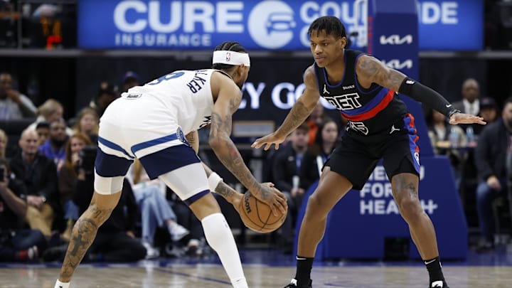 Jan 4, 2025; Detroit, Michigan, USA; Minnesota Timberwolves guard Nickeil Alexander-Walker (9) is defended by Detroit Pistons guard Marcus Sasser (25) in the first half  at Little Caesars Arena. Mandatory Credit: Rick Osentoski-Imagn Images