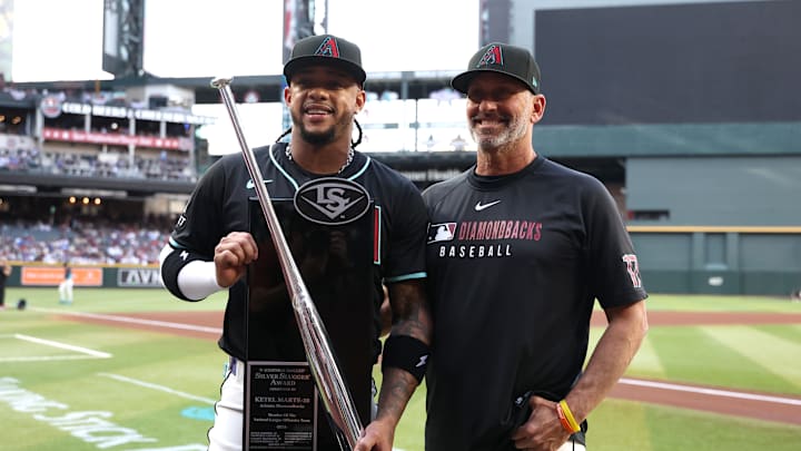 Arizona Diamondbacks second baseman Ketel Marte and manager Torey Lovullo celebrate awards from the 2024 MLB season.