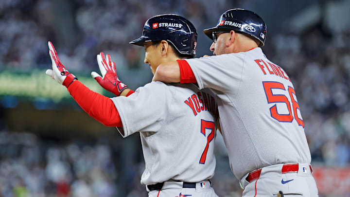 Sep 30, 2025; Bronx, New York, USA; Boston Red Sox outfielder Masataka Yoshida (7) celebrates with Boston Red Sox first base coach/infield instructor José David Flores (58) after hitting a two run RBI during the seventh inning against the New York Yankees during game one of the Wildcard round for the 2025 MLB playoffs at Yankee Stadium. Mandatory Credit: Brad Penner-Imagn Images