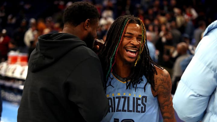 Nov 29, 2024; Memphis, Tennessee, USA; Memphis Grizzlies guard Ja Morant (12) embraces with New Orleans Pelicans forward Zion Williamson (left) after the game at FedExForum. Mandatory Credit: Petre Thomas-Imagn Images