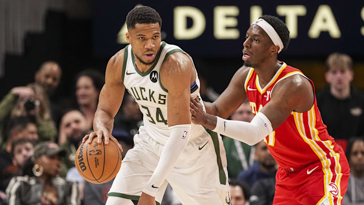 Mar 4, 2025; Atlanta, Georgia, USA: Milwaukee Bucks forward Giannis Antetokounmpo (34) controls the ball against Atlanta Hawks forward Onyeka Okongwu (17) during the second half at State Farm Arena. Mandatory Credit: Dale Zanine-Imagn Images