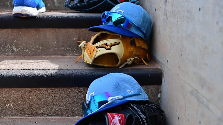 Mar 12, 2024; Salt River Pima-Maricopa, Arizona, USA; General view of Kansas City Royals hats and gloves in the first inning against the Colorado Rockies during a spring training game at Salt River Fields at Talking Stick. Mandatory Credit: Matt Kartozian-Imagn Images Mar 12, 2024; Salt River Pima-Maricopa, Arizona, USA; General view of Kansas City Royals hats and gloves in the first inning against the Colorado Rockies during a spring training game at Salt River Fields at Talking Stick. Mandatory Credit: Matt Kartozian-Imagn Images