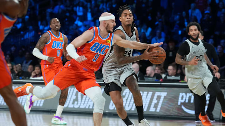 Dec 13, 2025; Las Vegas, Nevada, USA; San Antonio Spurs guard Devin Vassell (24) works past Oklahoma City Thunder guard Alex Caruso (9) during the fourth quarter at T-Mobile Arena. Mandatory Credit: Kirby Lee-Imagn Images Dec 13, 2025; Las Vegas, Nevada, USA; San Antonio Spurs guard Devin Vassell (24) works past Oklahoma City Thunder guard Alex Caruso (9) during the fourth quarter at T-Mobile Arena. Mandatory Credit: Kirby Lee-Imagn Images