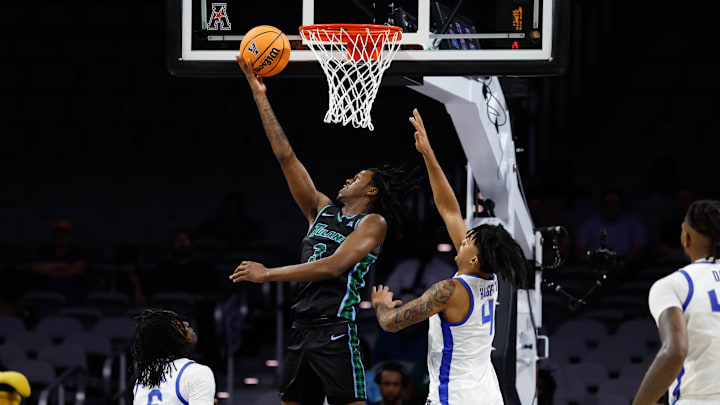 Mar 15, 2025; Fort Worth, TX, USA;  Tulane Green Wave guard Kam Williams (3) scores a layup against Memphis Tigers guard PJ Haggerty (4) during the second half at Dickies Arena.