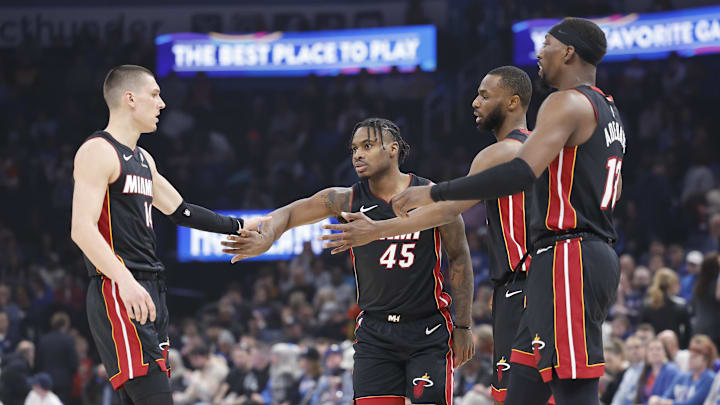 Feb 12, 2025; Oklahoma City, Oklahoma, USA; Miami Heat guard Tyler Herro (14), guard Davion Mitchell (45), forward Andrew Wiggins (22) and center Bam Adebayo (13) high five after a play against the Oklahoma City Thunder during the first quarter at Paycom Center. Mandatory Credit: Alonzo Adams-Imagn Images